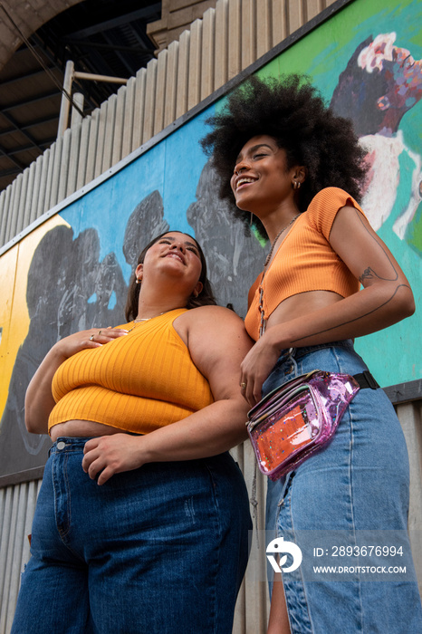 Two young women in street, low angle view