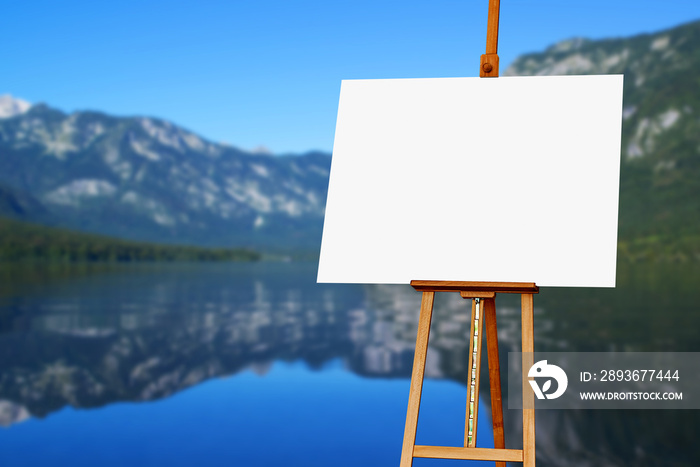 Blank painter artist canvas on easel with lake in background