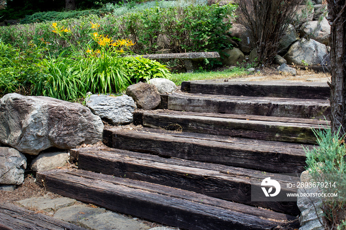 wooden stairs with boulders and golden flowers