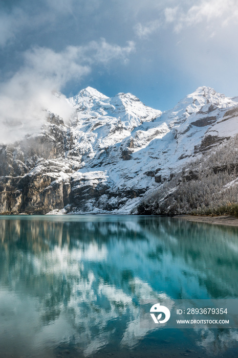 early winter with first snow at mountain lake Oeschinensee