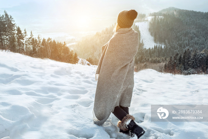 快乐的女人旅行者在雪地上看美丽的w