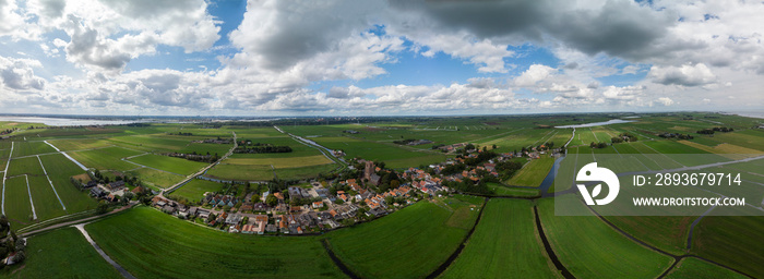 Dramatic aerial panoramic view of the agrarian green pasture fields with its irrigation infrastructu