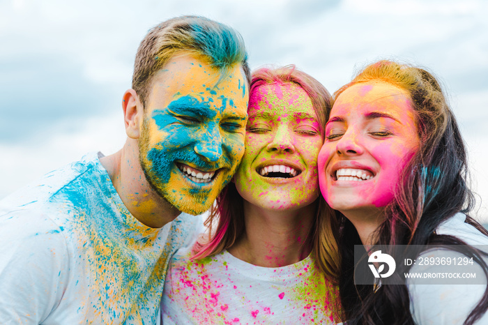 happy group of friends with closed eyes smiling outdoors