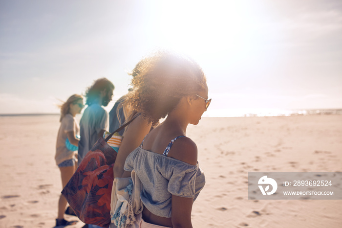 Friends walking along the beach on a sunny day