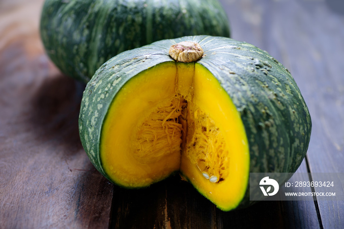 Green pumpkins on wooden background, organic vegetable