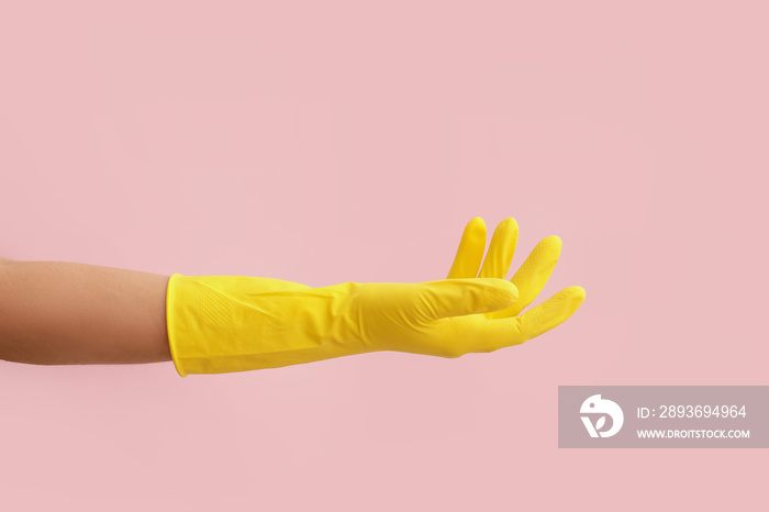 Hand in rubber glove on color background