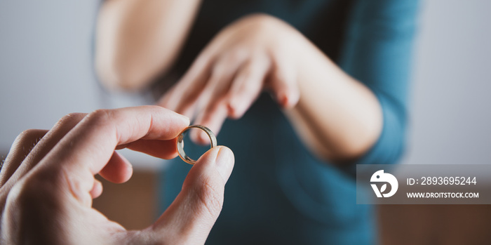 man and happy woman hand ring