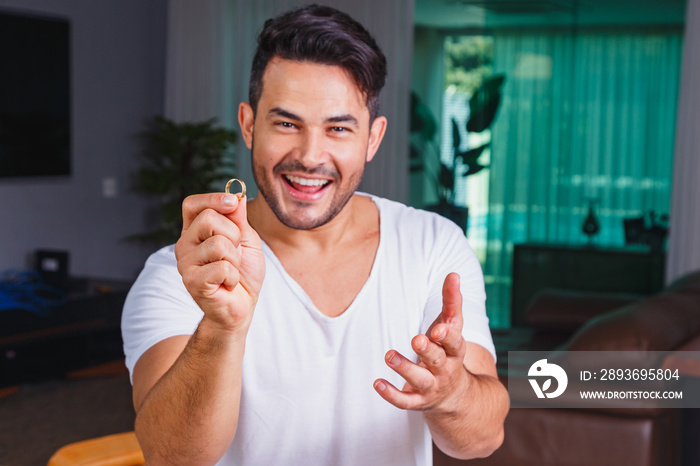 Man holding wedding ring in hand. Dating or marriage request concept