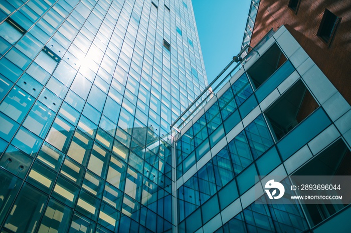 Low angle shot of a business building with glass walls under the sunlight