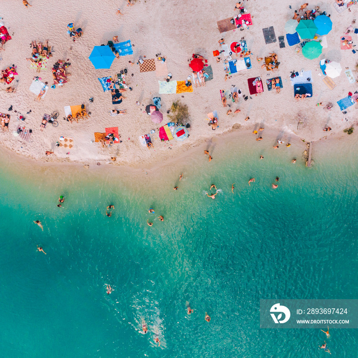 aerial view of sunny sandy beach with blue azure water. summer vacation