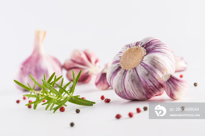 Garlic Cloves and Bulbs with rosemary and pepper.