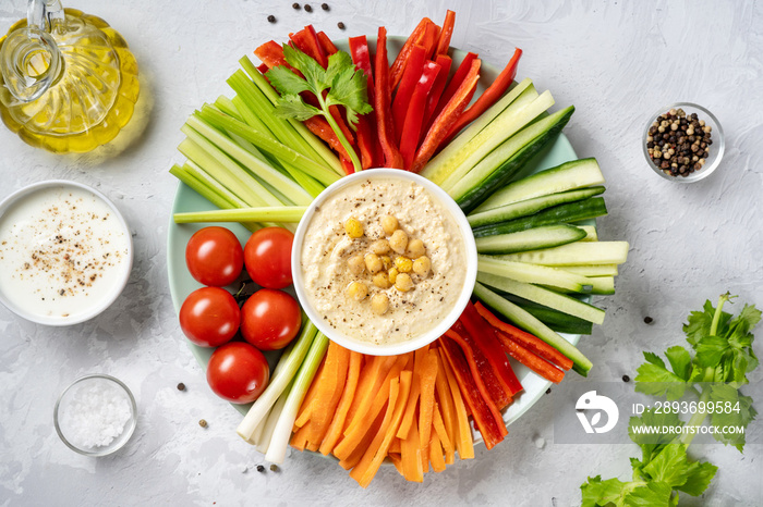 Plate with assorted fresh vegetable sticks with dips