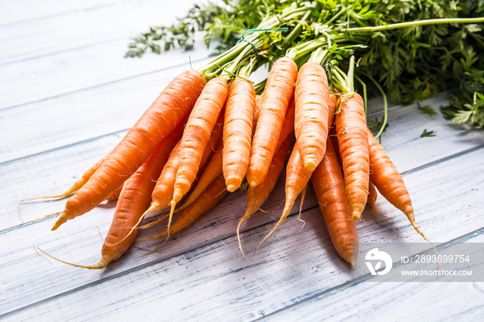 Bunch of fresh carrot on wooden table