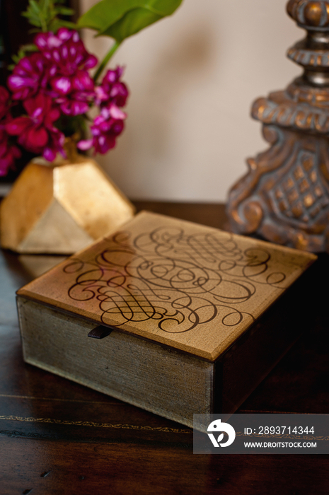 Close-up of a designed wooden box on table at home