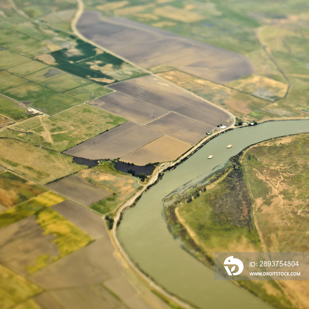 Aerial View of a River Passing Through Farmland