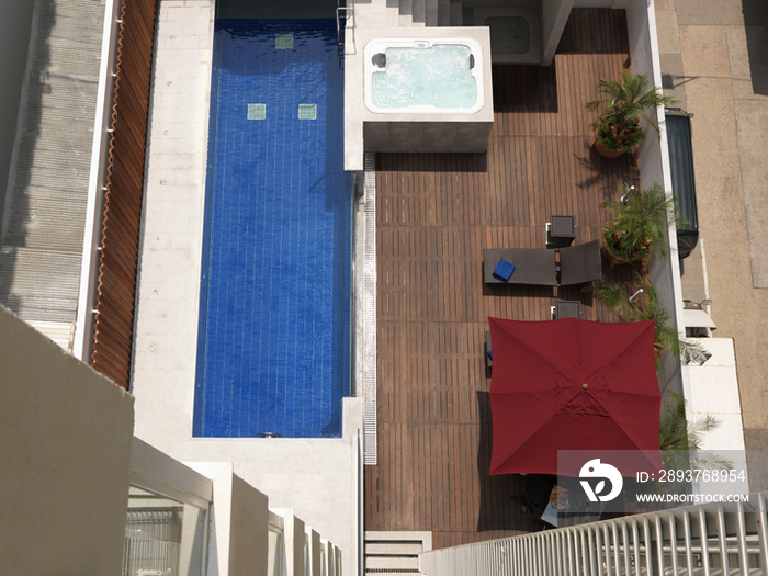 High angle view of backyard patio and swimming pool