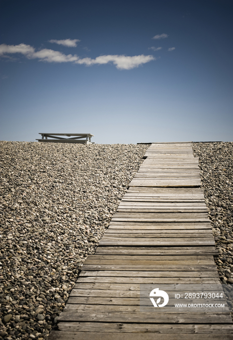 Wooden Walkway and Picnic Table at the Beach