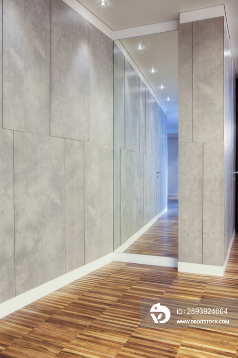 Reflection of recessed lights in mirror with parquet flooring