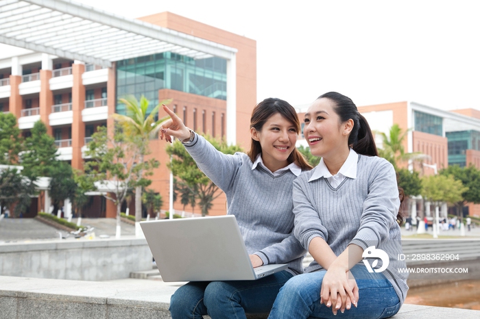 年轻大学生在校园里使用笔记本电脑