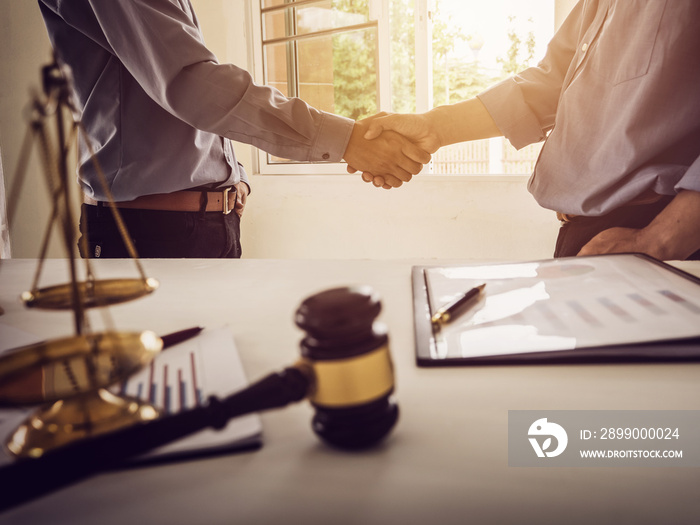 Shaking hands partnership tax lawyer and real estate agent.