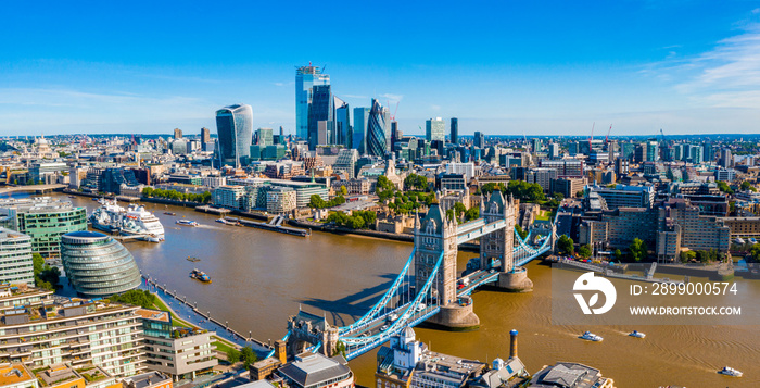 Tower Bridge in London, the UK. Sunset with beautiful clouds. Drawbridge opening. One of English symbols. Aerial view from above.