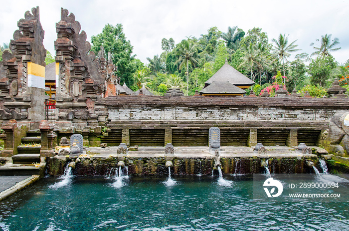 Pool with holy water in Tirta Empul temple (Bali, Indonesia)