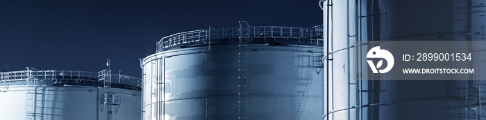 Fuel tanks in the port, close-up. Panoramic view. Fuel and power generation, industry, environmental damage, ecological issues. Dark industrial scene