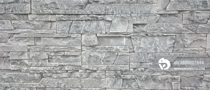 Elegant stone cladding wall made of gray granite with different shades