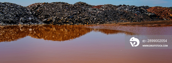 waste of mining industry rainwater colored with ferrous salts, pollution of the environment.