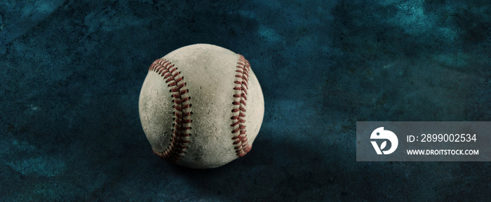 Old used baseball ball with negative space on background of sport banner.