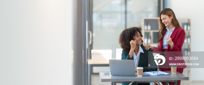 Young trader mixed race woman in formal suit friends consulting and discussing with stock market and cryptocurrency in online trading application.