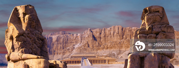 Colossi of Memnon Luxor Thebes against the background of dawn in the Egypt