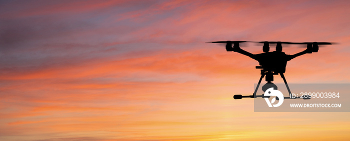 Silhouette of a drone on a sunset background