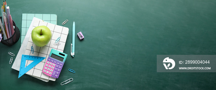 Set of school supplies with apple on chalkboard with space for text