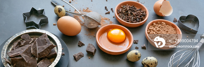 Mix of baking dessert ingredients on dark background, culinary flat lay