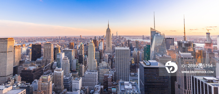 Panoramic photo of New York City Skyline in Manhattan downtown with Empire State Building and skyscrapers at sunset USA