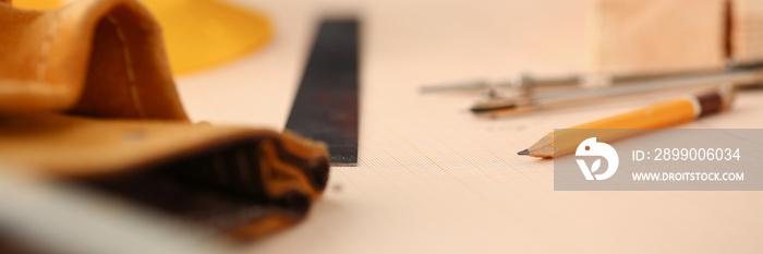 Drafting tools lying on desk on scaled paper closeup. Manual job DIY inspiration improvement job fix shop hard hat joinery startup workplace idea designer career ruler industrial education