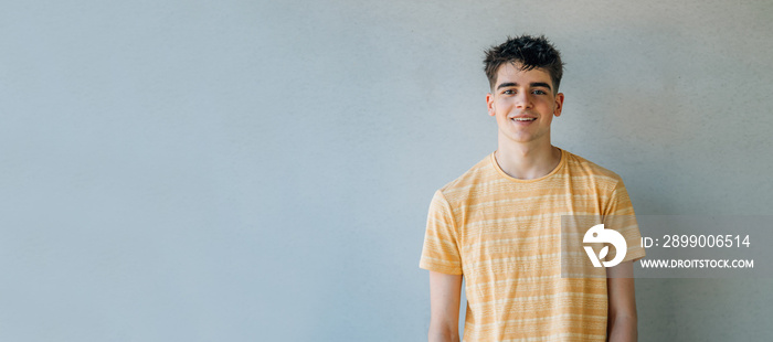 casual teenager portrait isolated on wall background