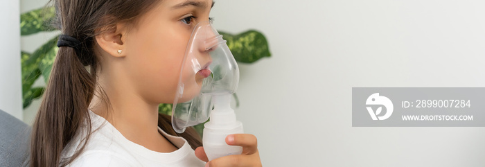 sick little girl makes inhalation over grey background with copy space. Girl making inhalation with nebulizer at home. child asthma inhaler inhalation nebulizer steam sick cough