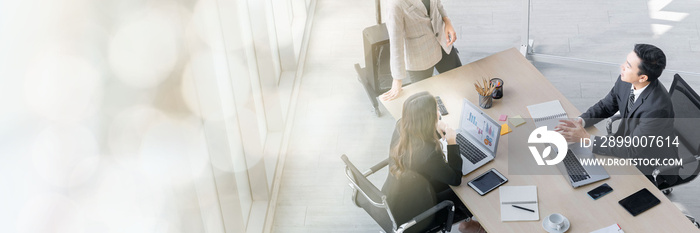 A group of young Asian businessmen Talking and planning work happily and have fun. at the company’s office web banner with copy space on left