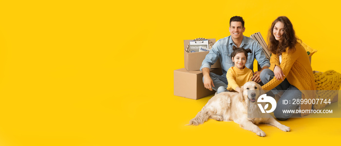 Happy family with dog and belongings on yellow background with space for text. Moving day