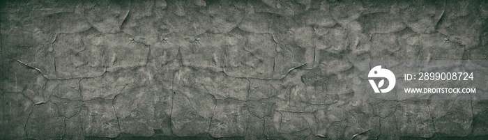 Dark cracked concrete wall wide retro texture. Aged cement surface horizontal panorama. Panoramic vintage background