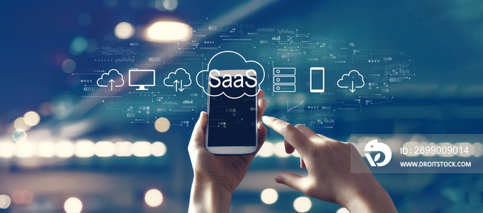 SaaS - software as a service concept with person using a smartphone