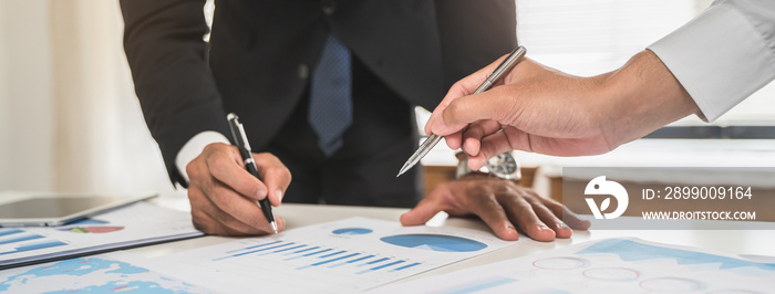 Close up hands of financial planner pointing in chart explain plan to invest.