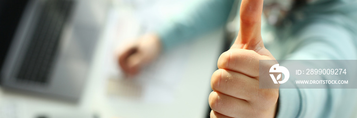 A young designer holds a pen from a tablet in his