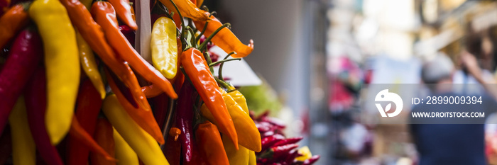 Spicy pepper colorfu chili on a flea food market in the street. Banner header of food store