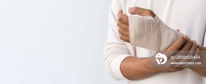 close up adult man hand with bandage support after get injured by accident for insurance claim and health lifestyle concept