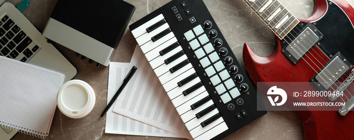 Musician workplace on gray textured table, top view