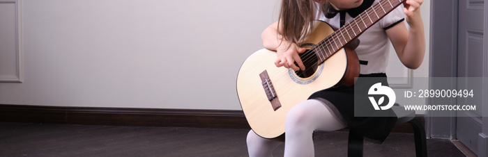 Learning to play the guitar. Music education and extra-curricular lessons.