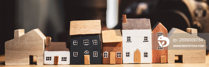 home in brown recycled paper  model on wooden table in Garden background. Eco friendly house.